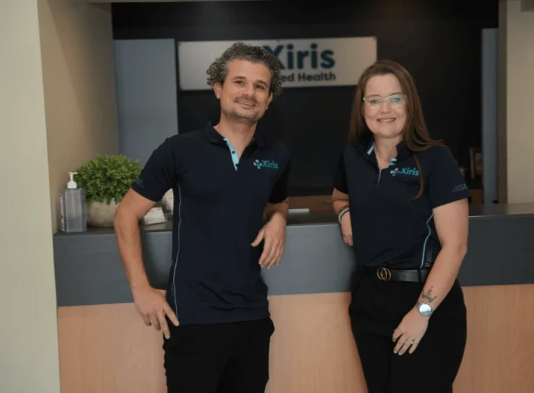 Two staff members in uniform at Xiris Allied Health
